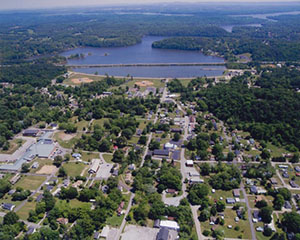 View of Soddy Daisy, Tennessee, showing lush green trees, a blue sky, and a calm lake in the distance.