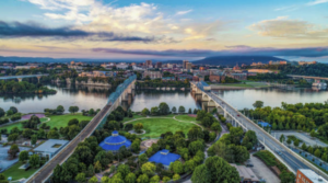 A picturesque Chattanooga landscape showcasing lush greenery, rural homes, and a serene environment, representing the area's USDA loan eligibility for homebuyers.