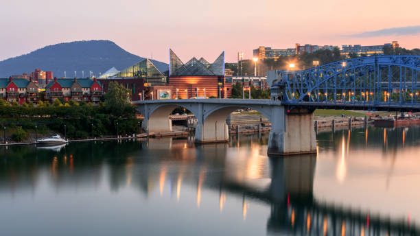 Scenic view of the Tennessee River, Walnut Street Bridge, and the Tennessee Aquarium with mountains in the background